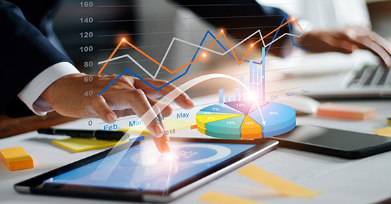 Businessman using tablet and laptop analyzing sales data and economic growth graph chart. Business strategy. Digital marketing. Business innovation technology concept (Demo)