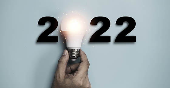 Hand holding Light bulb with 2022 year for happy new year idea and creative thinking concept Demo