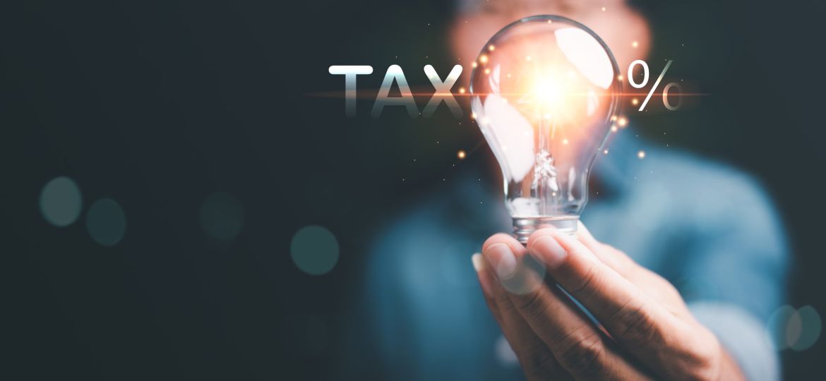 vecteezy_businessman-holding-a-light-bulb-effective-tax-deduction_13395786-scaled