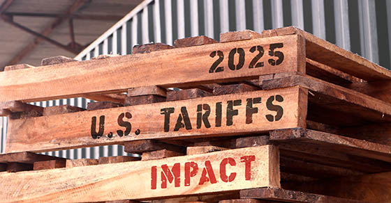 2025UsTariffsImpactTextWrittenOnPiled-upPalletsSupply