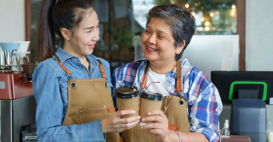 AsianElderlyWomanIsRetiredPensionerHoldsDisposableCoffeeCup