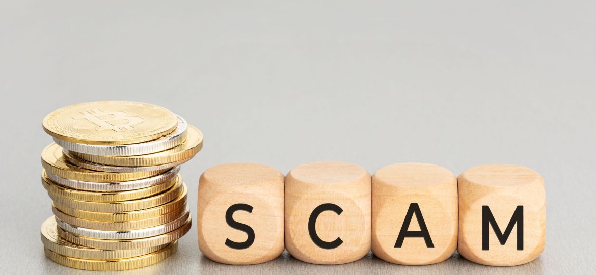 Cryptocurrency Scam concept Stacked crypto coins and wooden blocks with text Copy space